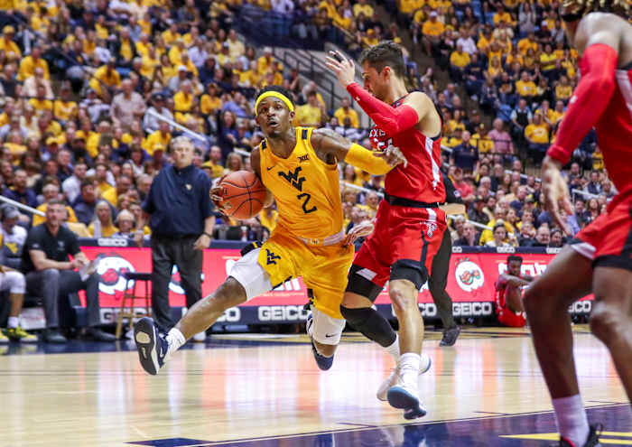 West Virginia Mountaineers guard Brandon Knapper (2) drives down the lane and is defended by Texas Tech Red Raiders guard Davide Moretti (25) during the second half at WVU Coliseum.